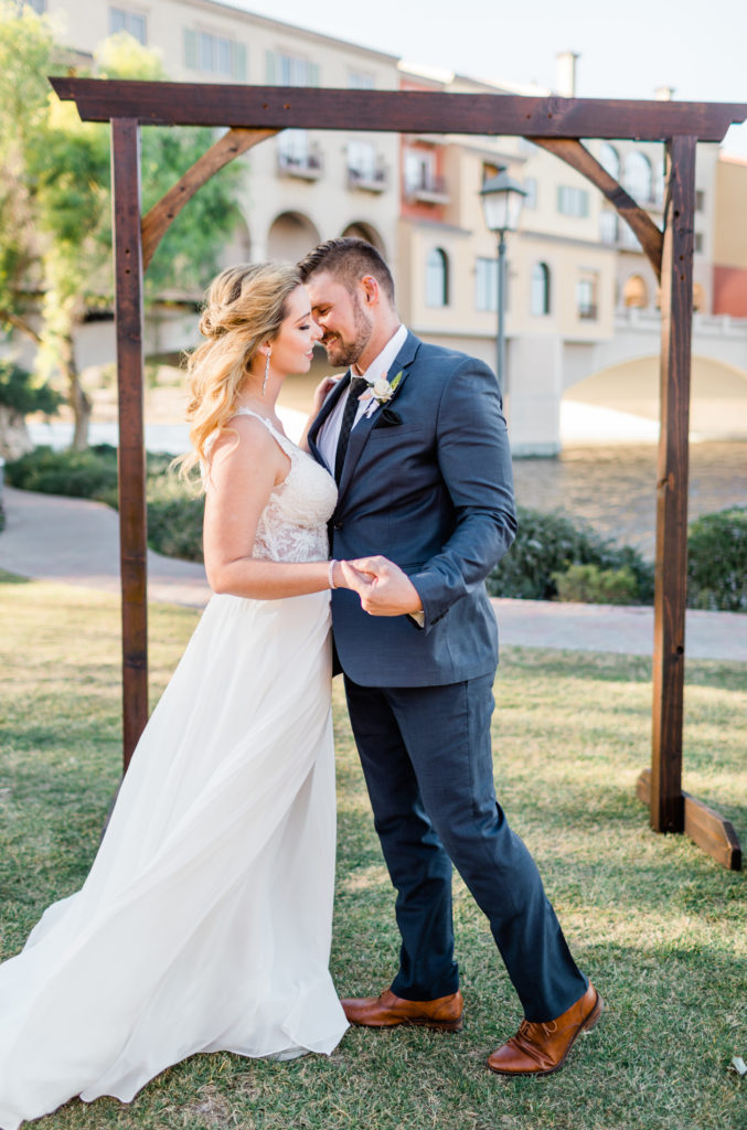 bride and groom kissing during their ceremony of their wedding day at A Moment in Time Events venue