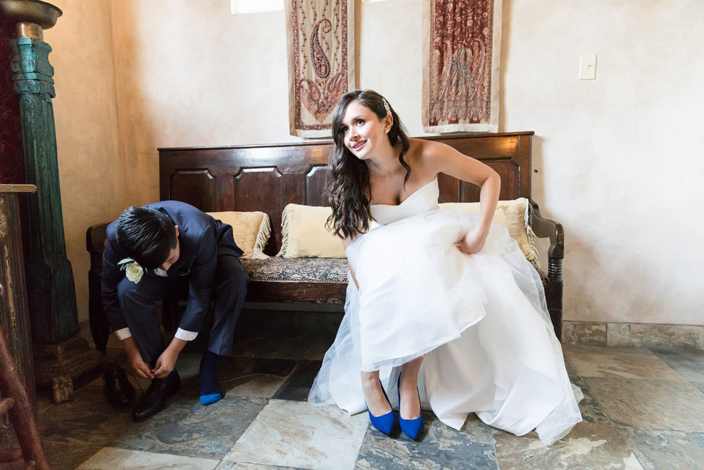 bride putting on her blue heels