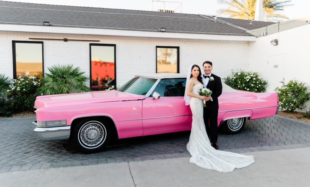 Newlyweds next to the pink Cadillac at the Little Vegas Wedding Chapel 