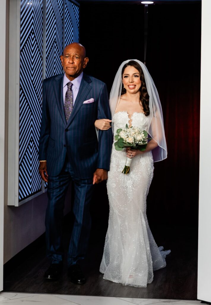 The bride being walked up the aisle on her wedding day