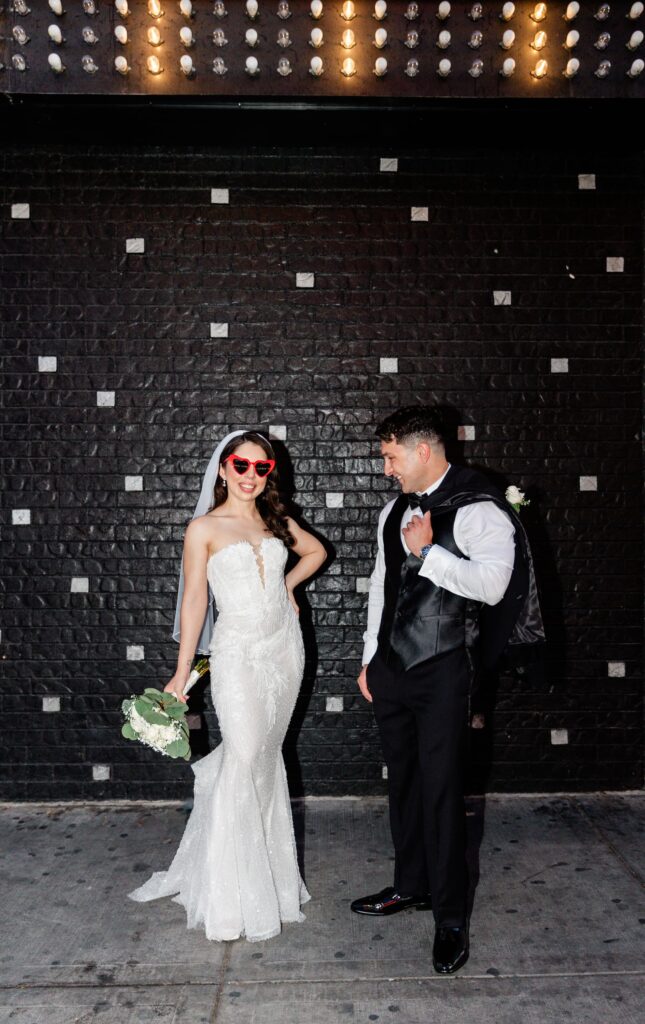 Newlyweds having fun at Fremont Street during their elopement in Las Vegas